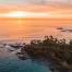 Bright orange sunset along the Orange County, California coastline overlooking the Pacific Ocean.